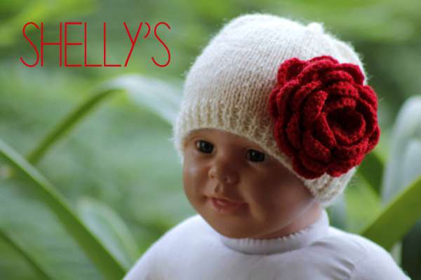 Hand-knit cap with crocheted rose 